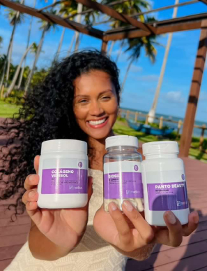 Influencer Babi Brito com uma paisagem de praia e coqueiros ao fundo mostrando produtos Medbox.